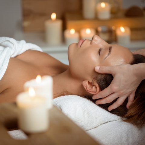 young-woman-having-face-massage-relaxing-spa-salon